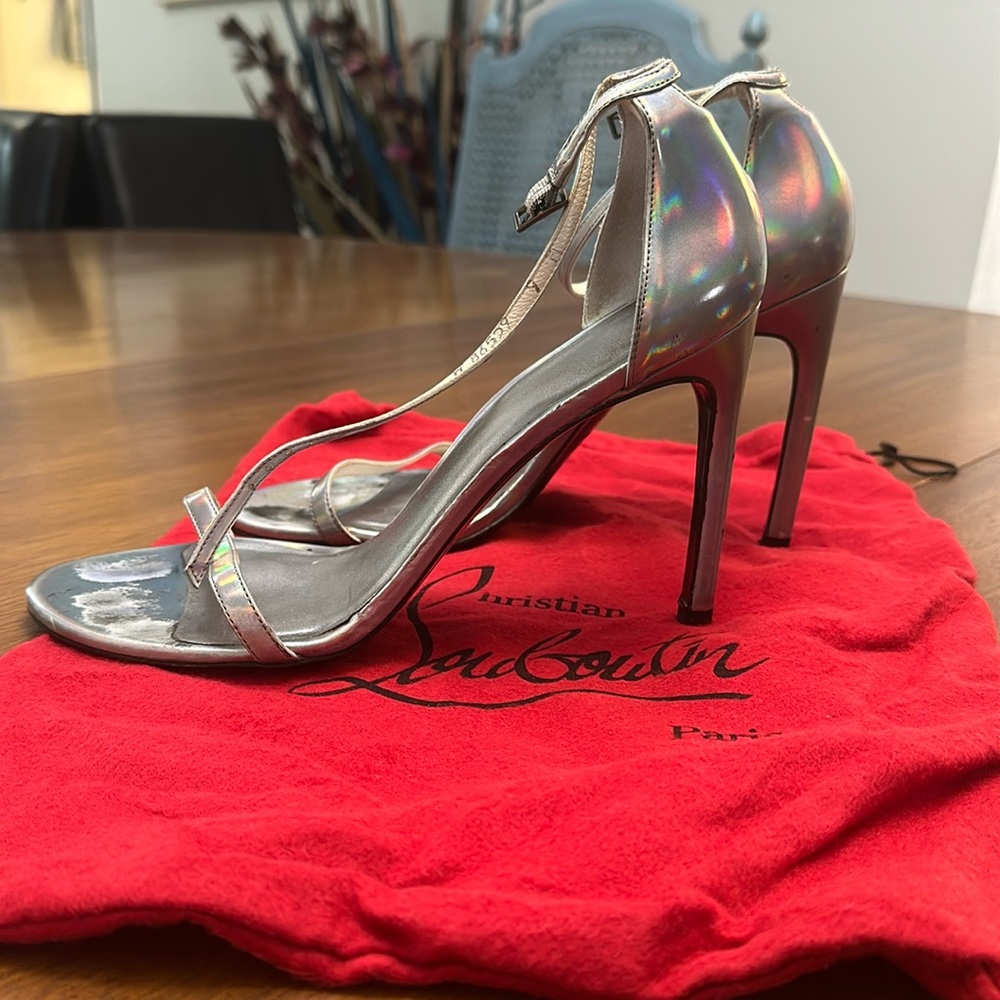 Silver 4 inch heels. leather Stuart Weitzman. open toe. closed back. heels